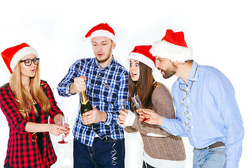 Image showing Many young women and men drinking at christmas party