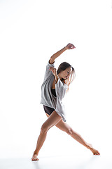 Image showing Young beautiful dancer in beige dress dancing on white background