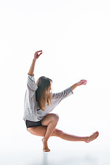 Image showing Young beautiful dancer in beige dress dancing on white background