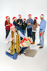 Image showing Many young women and men drinking at christmas party