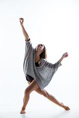 Image showing Young beautiful dancer in beige dress dancing on white background