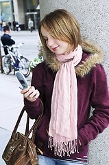 Image showing Teenage girl text messaging on cell phone