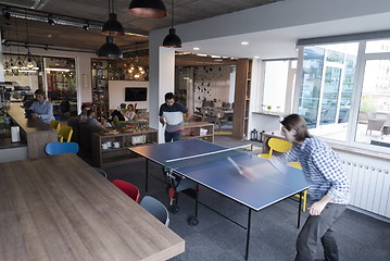 Image showing playing ping pong tennis at creative office space