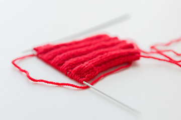 Image showing hand-knitted item with knitting needles