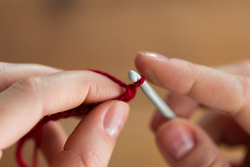 Image showing close up of hands knitting with crochet hook