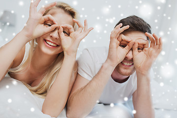 Image showing happy couple lying in bed at home