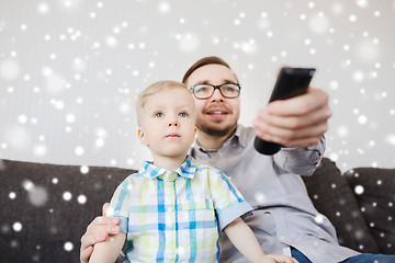 Image showing father and son with remote watching tv at home