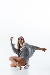 Image showing Young beautiful dancer in beige dress dancing on white background