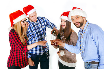 Image showing Many young women and men drinking at christmas party