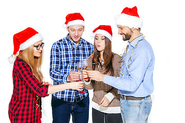 Image showing Many young women and men drinking at christmas party