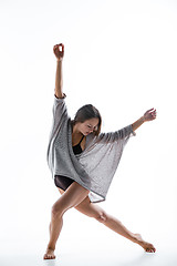 Image showing Young beautiful dancer in beige dress dancing on white background