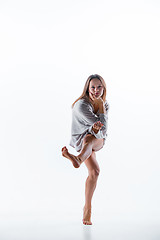 Image showing Young beautiful dancer in beige dress dancing on white background