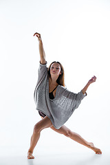 Image showing Young beautiful dancer in beige dress dancing on white background