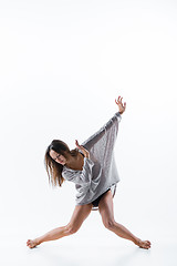 Image showing Young beautiful dancer in beige dress dancing on white background