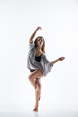 Image showing Young beautiful dancer in beige dress dancing on white background