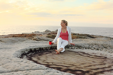 Image showing Carefree woman enjoys morning coffee