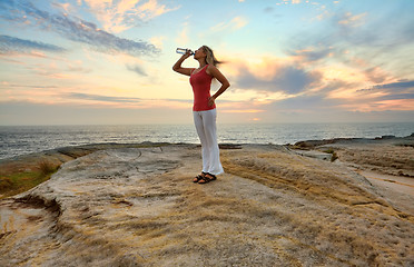 Image showing Woman drinking bottled water outdoors