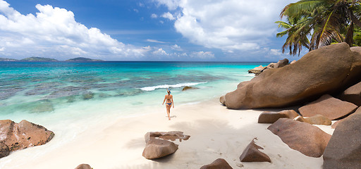 Image showing Woman enjoying Anse Patates picture perfect beach on La Digue Island, Seychelles.