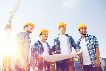 Image showing group of builders with tablet pc and blueprint