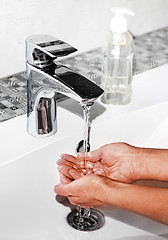 Image showing washing hands in modern sink