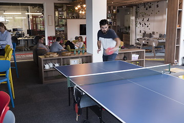 Image showing playing ping pong tennis at creative office space