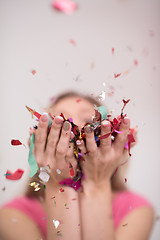 Image showing woman blowing confetti in the air