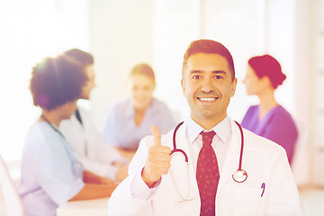 Image showing happy doctor over group of medics at hospital