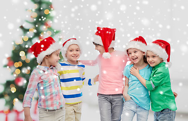 Image showing happy little children in christmas santa hats