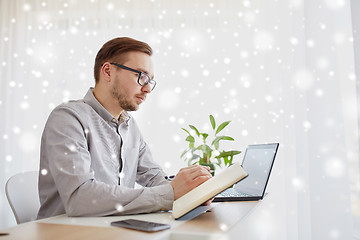 Image showing creative man or businessman writing to notebook