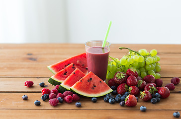 Image showing fruit and berry juice or smoothie on wooden  table