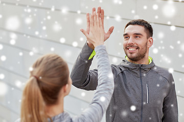 Image showing happy couple giving high five outdoors