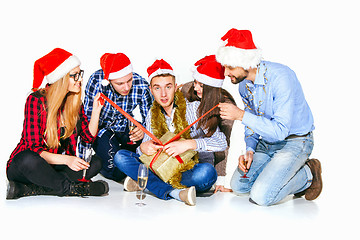 Image showing Many young women and men drinking at christmas party