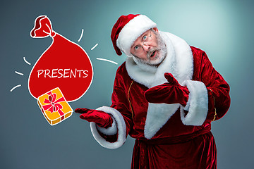 Image showing Santa Claus, presenting something.