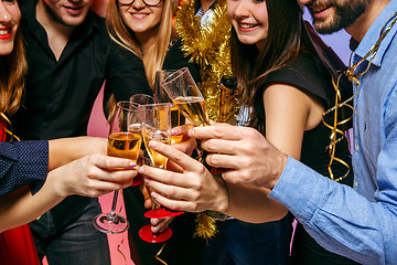 Image showing Many young women and men drinking at christmas party