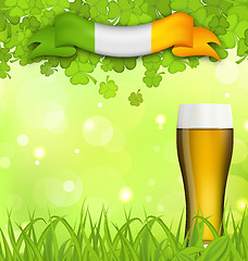 Image showing Glowing nature background with glass of beer, clovers, grass and