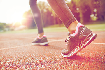 Image showing close up of woman feet running on track from back