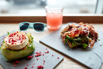 Image showing goat cheese and ham salads on cafe table