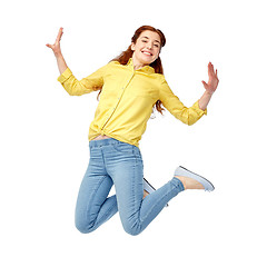 Image showing smiling young woman jumping in air