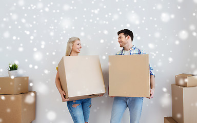 Image showing smiling couple with big boxes moving to new home