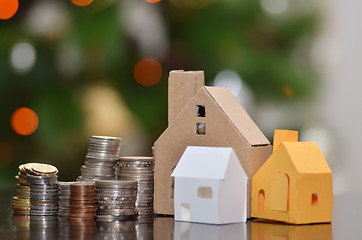 Image showing Paper house and stacks of coins standing