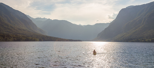 Image showing Family rowing in canoe boat on beautiful lake Bohinj, Slovenia.