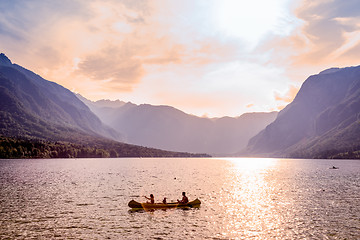 Image showing Family rowing in canoe boat on beautiful lake Bohinj, Slovenia.