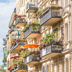 Image showing Traditional European Balcony with colorful flowers and flowerpots.