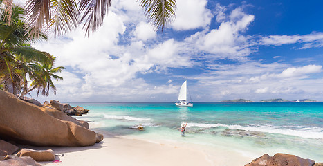 Image showing Woman enjoying Anse Patates picture perfect beach on La Digue Island, Seychelles.