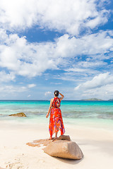 Image showing Woman enjoying Anse Patates picture perfect beach on La Digue Island, Seychelles.