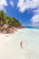 Image showing Woman enjoying Anse Patates picture perfect beach on La Digue Island, Seychelles.