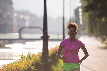 Image showing african american woman jogging in the city