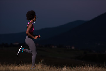 Image showing Young African american woman jogging in nature