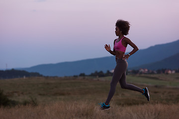 Image showing Young African american woman jogging in nature