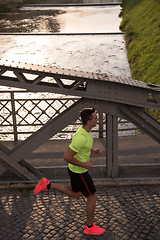 Image showing a young man jogging in the city